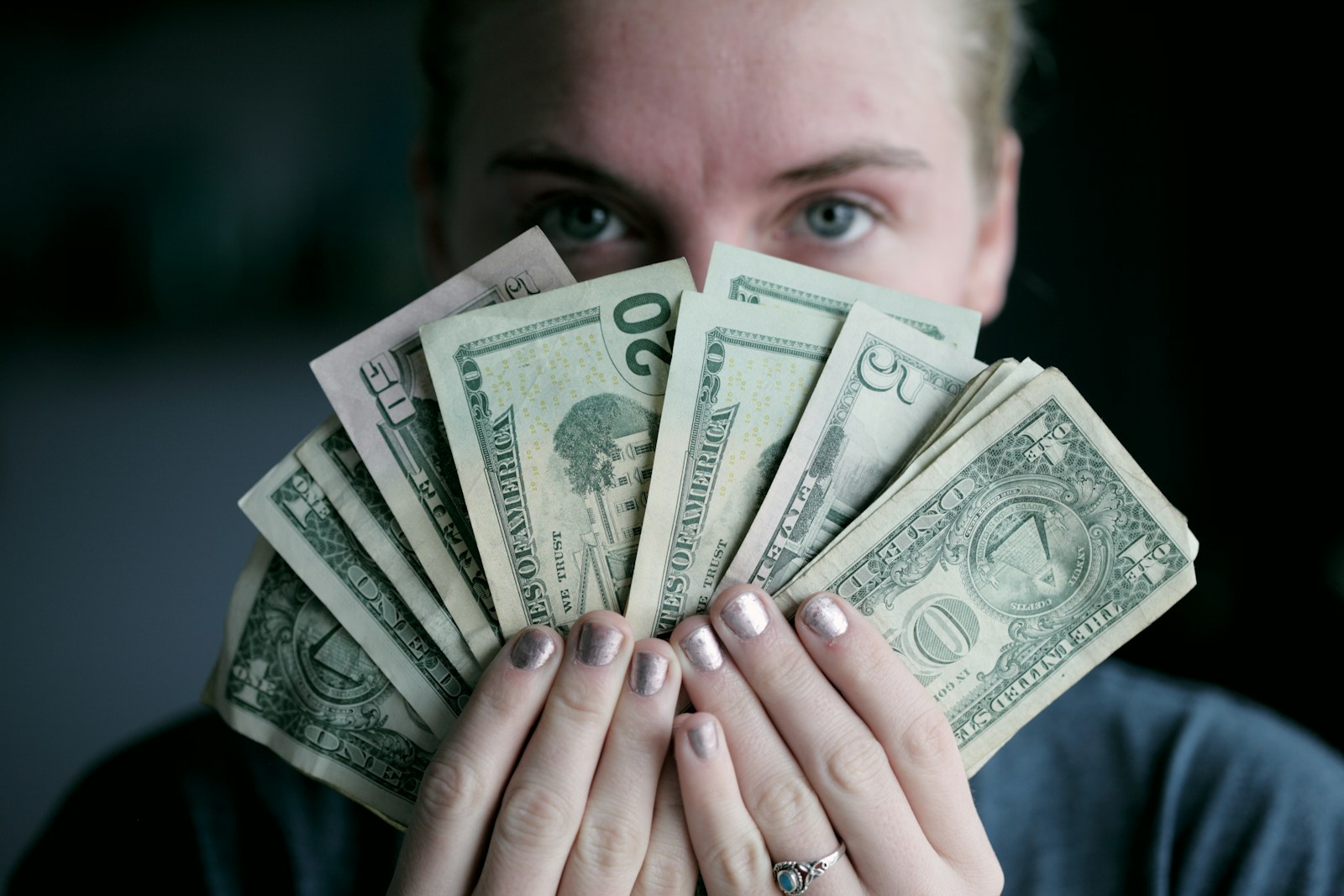 person holding fan of U.S. dollars banknote, Earn Passive Income